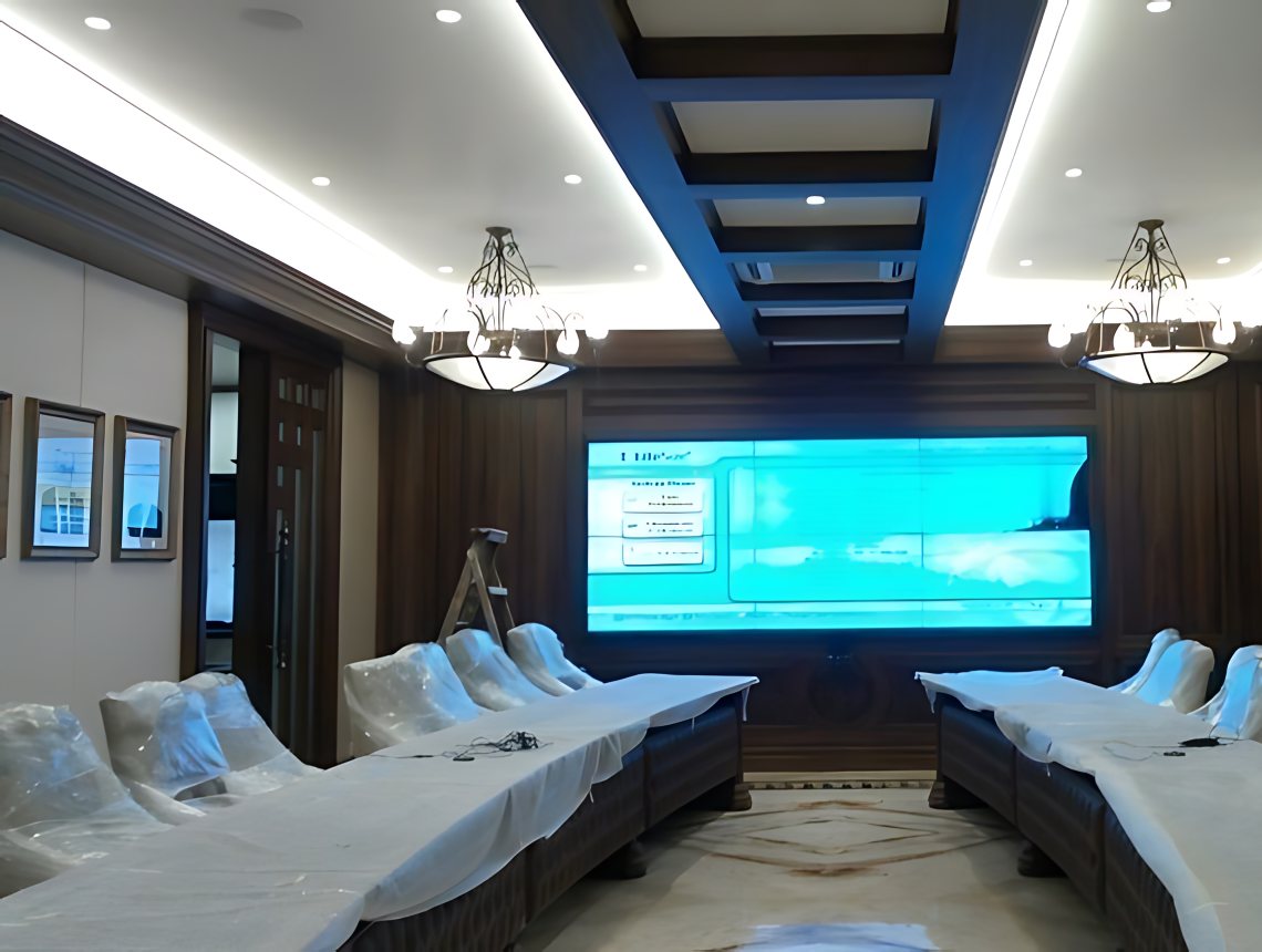 Jeena and Company boardroom: a 3 by 2 video wall at the head of the room, chairs still in their wrapping