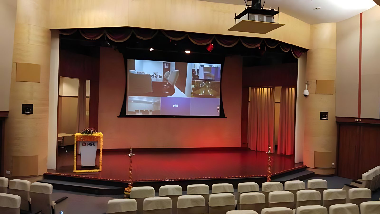 NSE auditorium at BKC: a projection screen above the stage, seen from the seating