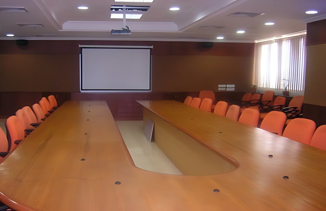 ONGC conference room completed by PROVAL: a long timber table, projector and screen
